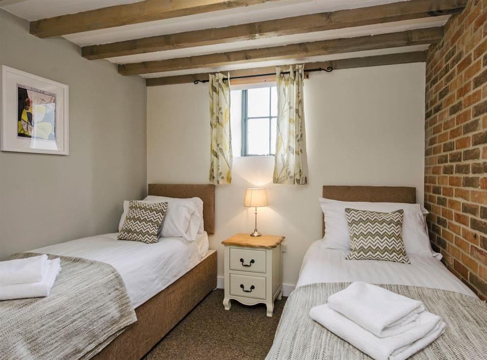 Charming twin bedroom with beams at Valley View Barn in Bradbourne, near Ashbourne, Derbyshire