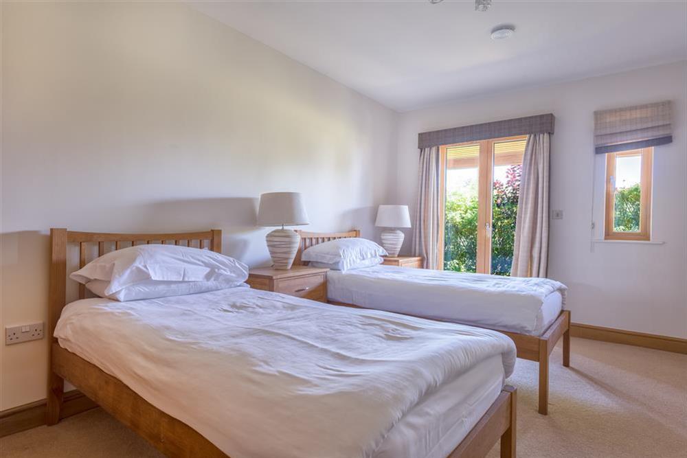 Ground floor bedroom with twin beds and French windows to the South at Vantage Point in Hillfield, Dartmouth