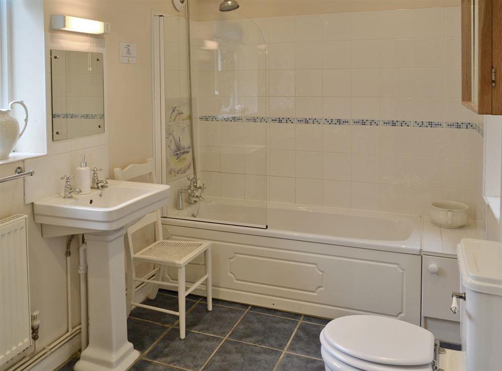 Family bathroom with shower over bath at Varley House in Saxmundham, Suffolk
