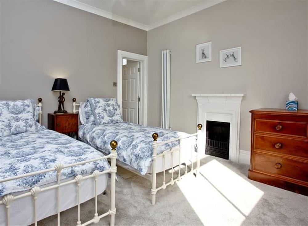 Bedroom with twin single beds at Veltham House Cottage in Bampton near Tiverton, Devon