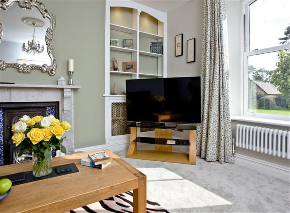 Comfortable living room with open fireplace at Veltham House Cottage in Bampton near Tiverton, Devon