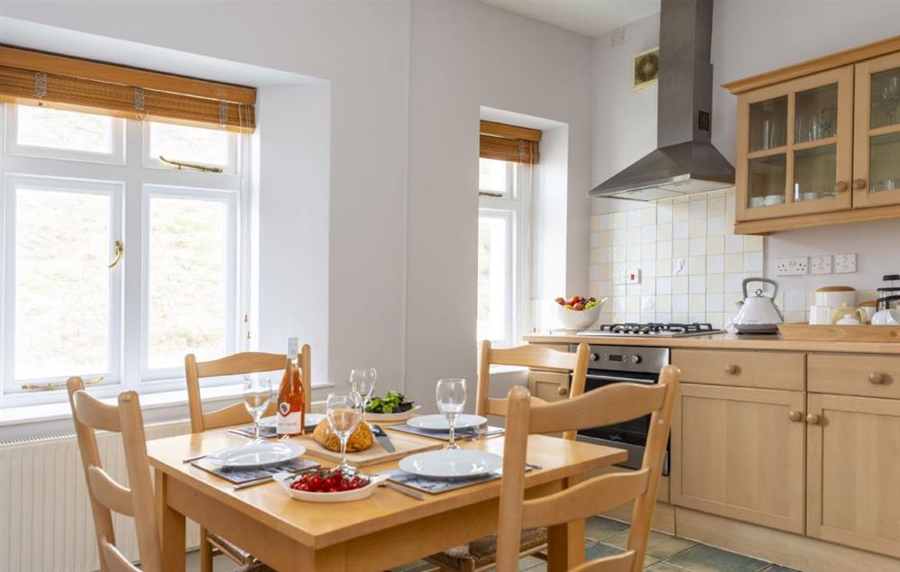 Spacious fully equipped kitchen and dining table seating four guests at Verity Cottage, Trevose Head Lighthouse