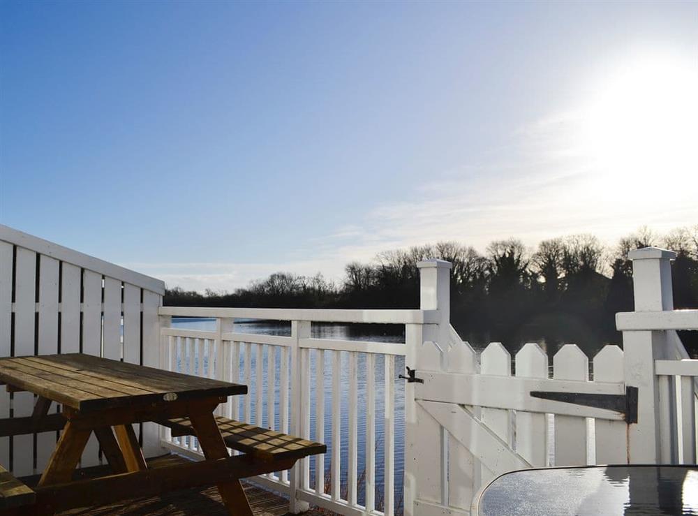 Terrace with furniture overlooking the lake at Vezelay in Nr Cirencester, Glos., Gloucestershire