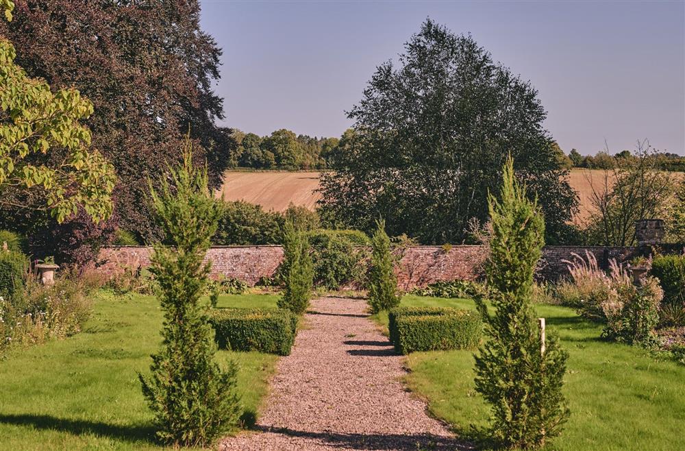 A cobbled pathway through the estate grounds overlooking the countryside