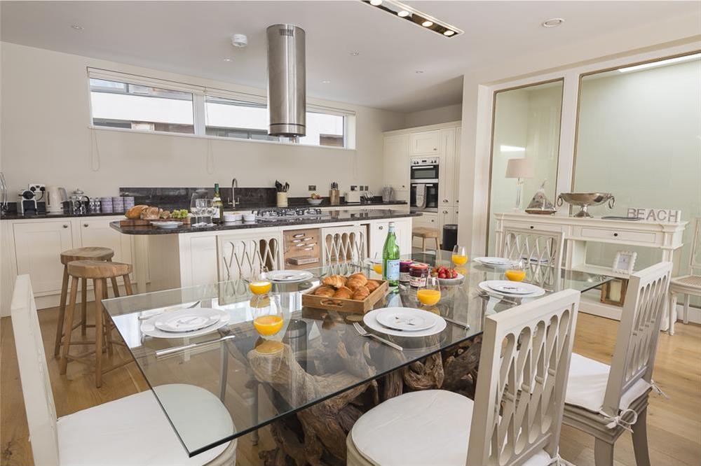 Elegant glass-topped dining table seating up to eight guests at Villa 1, Estura in , Salcombe
