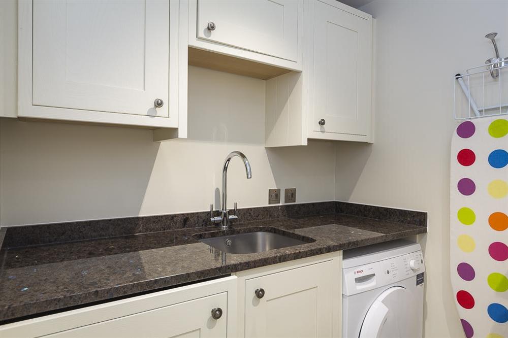 Utility room at lower ground floor level with washing machine and tumble dryer at Villa 1, Estura in , Salcombe