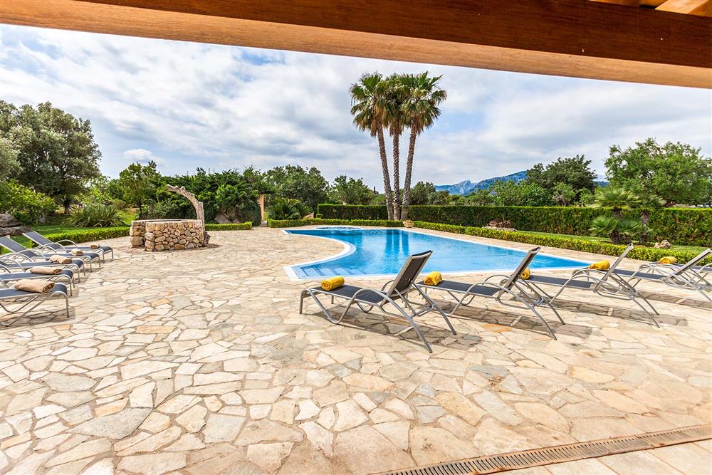 Terrace, sunloungers, pool at Villa Les Oliveres, Puerto Pollensa, Mallorca