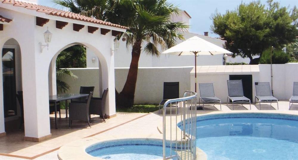 Swimming pool and shaded seating at Villa Raquel, Calan Forcat, Menorca