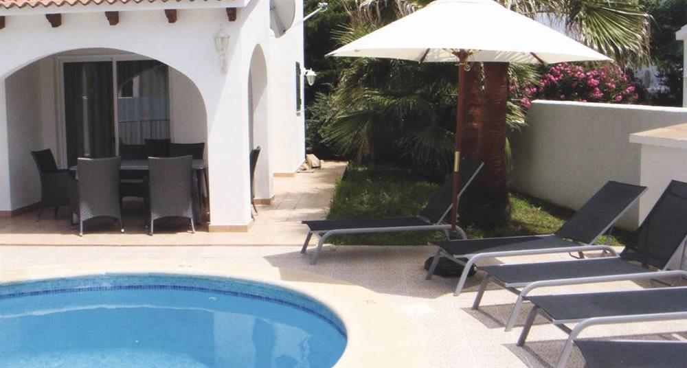 Swimming pool and sun loungers at Villa Raquel, Calan Forcat, Menorca