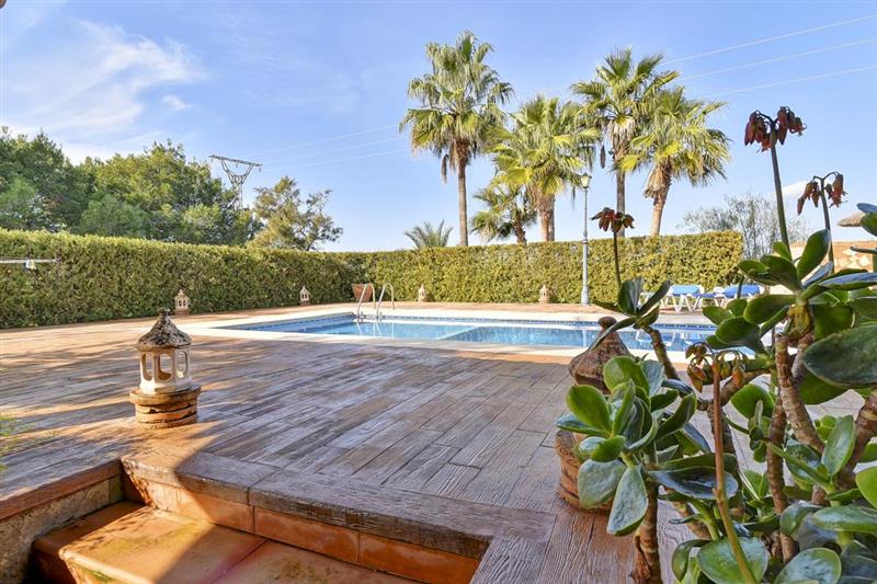 Swimming pool and garden at Villa Ses Covetes, Cala dOr, Spain