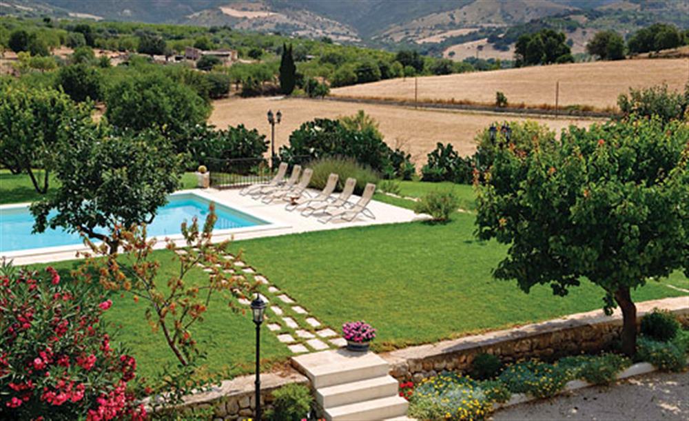Swimming pool in the lawned garden at Villa Spiga, Rosolini Sicily, Italy