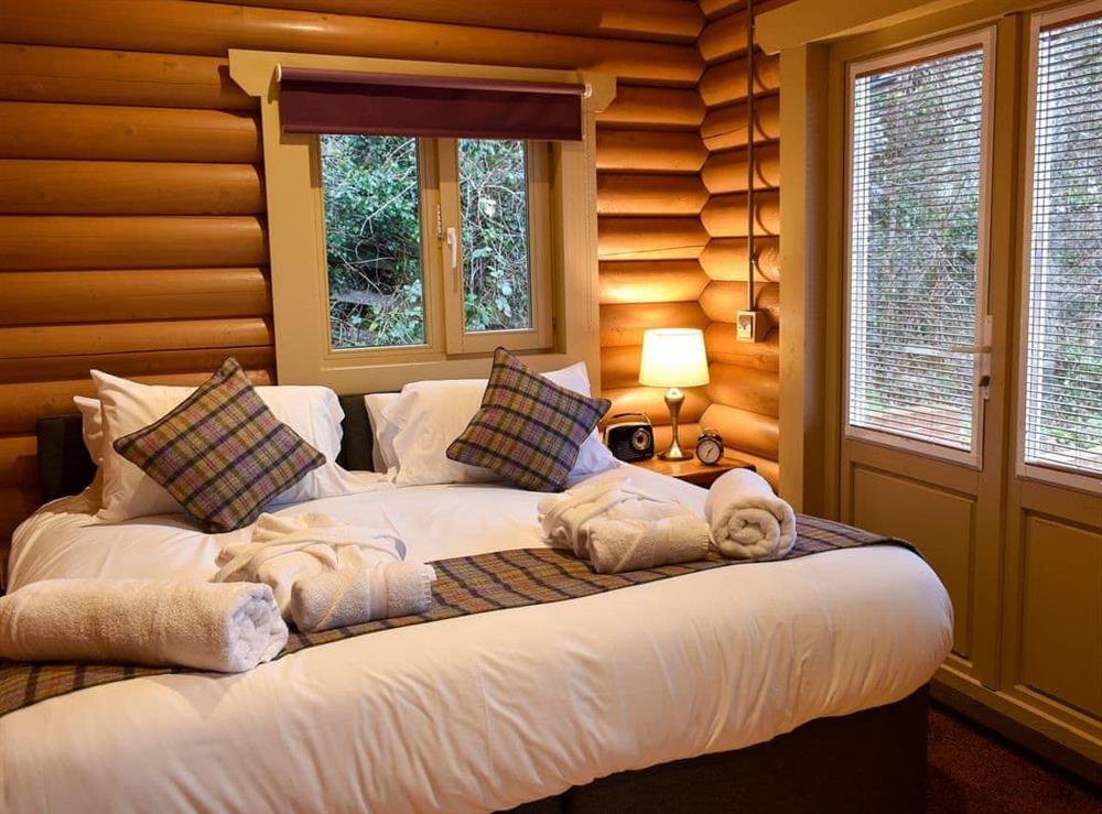 Relaxing bedroom with kingsize bed at Chesters Lodge, 