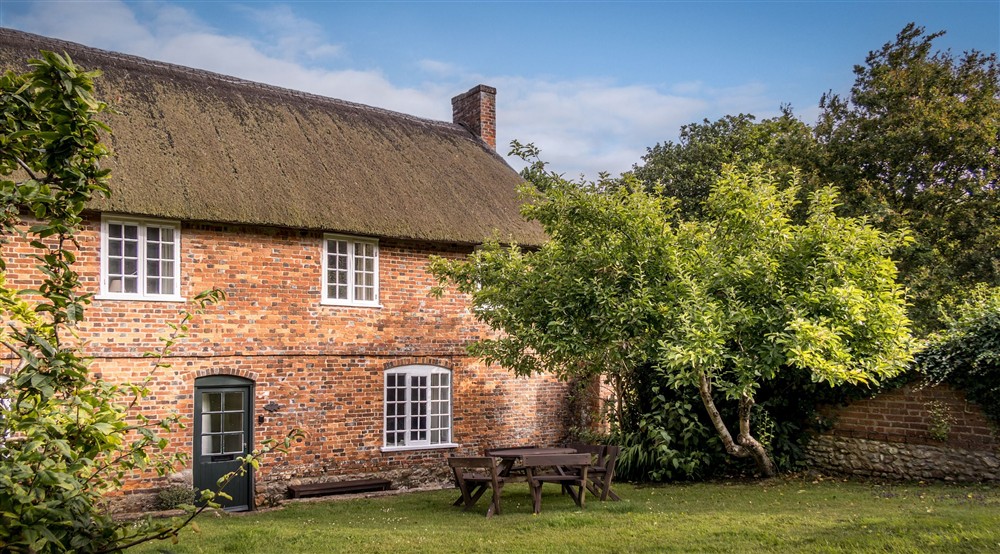 The exterior of Beech Cottage and the shared garden, Dorset at Vineyard Farm Cottage in Wareham, Dorset