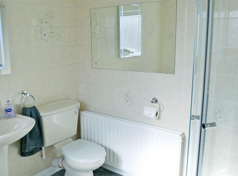 Bathroom with bath and shower cubicle at Violet Cottage in Newbiggin-by-the-Sea, Northumberland