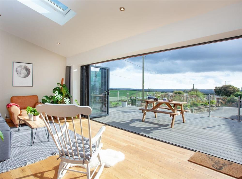 Living area with folding doors to patio area at Vredehoek in Blunts, near Saltash, Cornwall