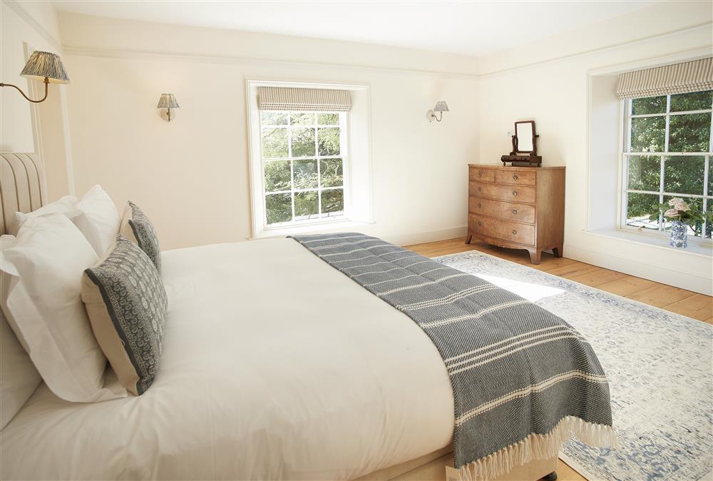 Bedroom one with 6’ super-king zip and link bed and en-suite bathroom (photo 2) at Walesby House, Walesby