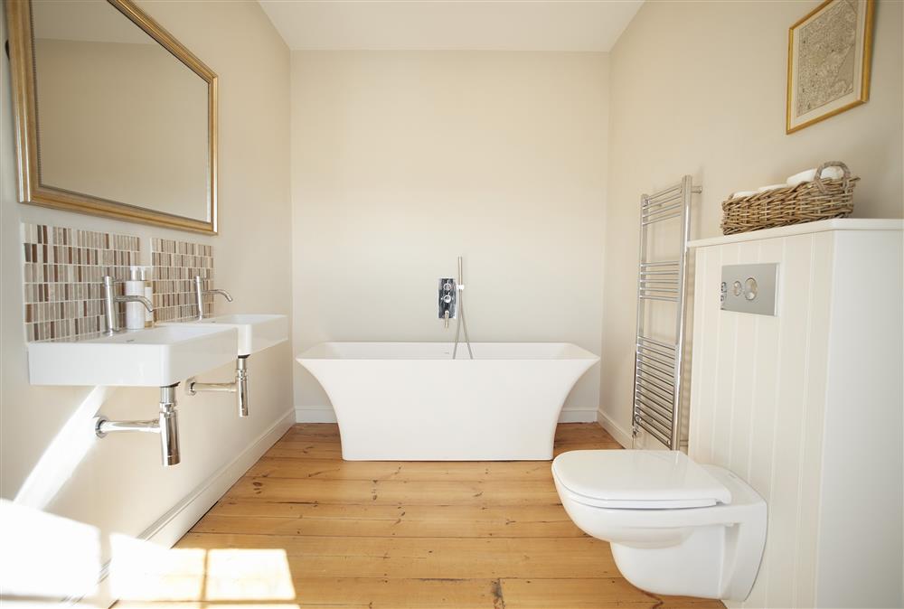 En-suite to bedroom one with bath and hand held shower attachment at Walesby House, Walesby
