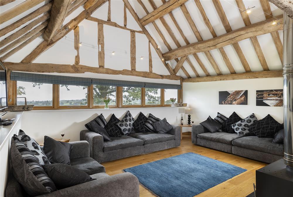 At the end of the living space is the sitting room with wood burning stove at Wall Hills Barn, Thornbury