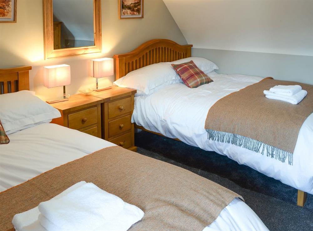 Delightful bedroom with twin double beds at Wallace House in Dornoch, near Tain, Sutherland