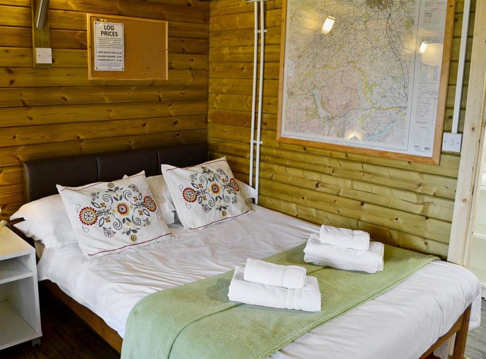 Comfortable sleeping area with double bed at Kestrel Cabin, 