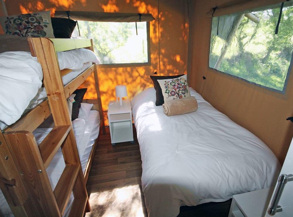 Cosy bedroom with  bunk bed and single bed at Safari Tent, 