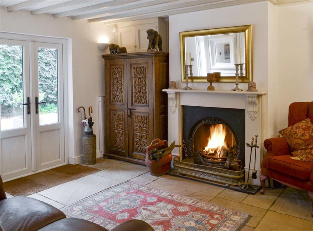 Additional seating area with open fire at Walnut Tree House in Tilney St Lawrence, near King’s Lynn, Norfolk