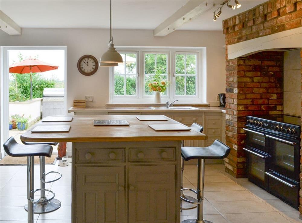 Fully appointed kitchen with dining ’island’ at Walnut Tree House in Tilney St Lawrence, near King’s Lynn, Norfolk