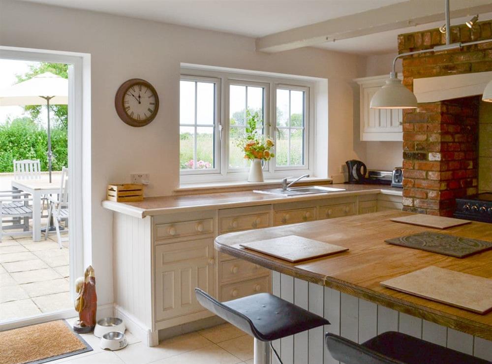 Well-equipped kitchen with door to patio at Walnut Tree House in Tilney St Lawrence, near King’s Lynn, Norfolk