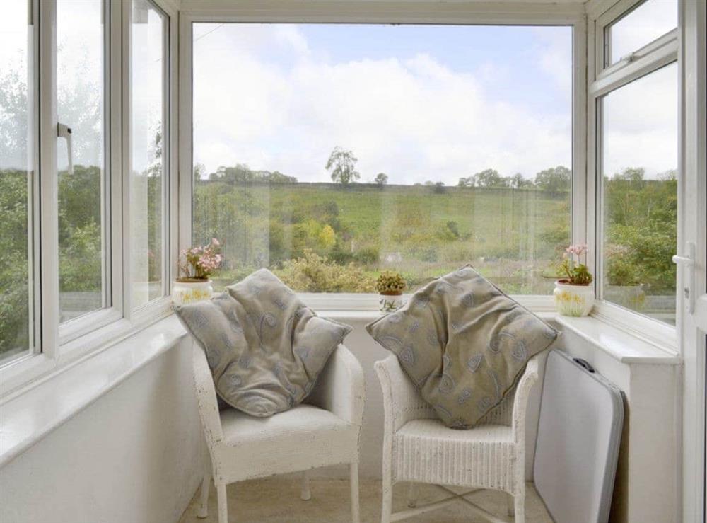 Great rural views from the porch seating area at Walter’s Cottage in West Compton, near Shepton Mallet, Somerset