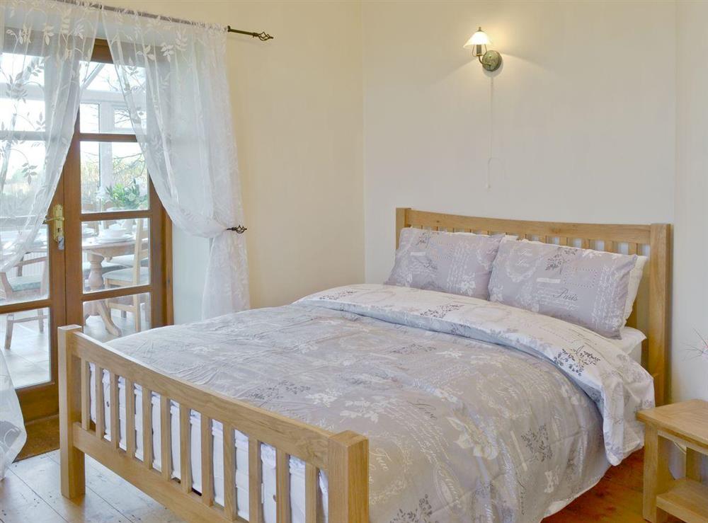 Lovely double bedroom with French doors to conservatory at Warleigh Lodge in Tamerton Foliot, near Plymouth, Devon