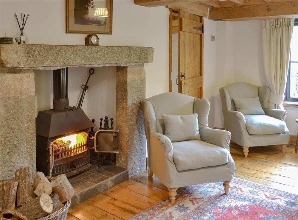 Warm and welcoming living room with wood burner in feature fireplaceu0009 at Warmhill Farmhouse in Newton Abbot, Devon