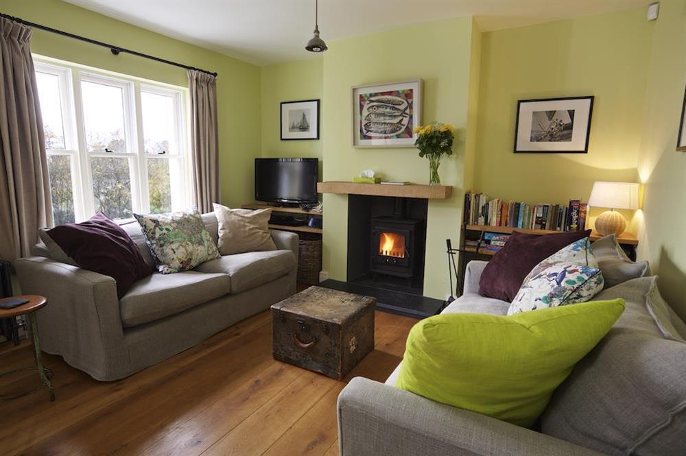 A spacious and well presented sitting room with views over the garden at Warren Cottage in Little Dartmouth Farm, Nr Dartmouth