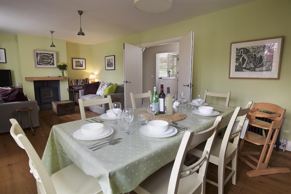 Dining area with table and six chairs at Warren Cottage in Little Dartmouth Farm, Nr Dartmouth