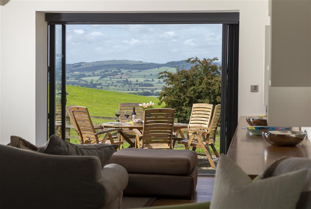 View onto the garden with gravel outdoor seating area at Wassell Barn, Craven Arms