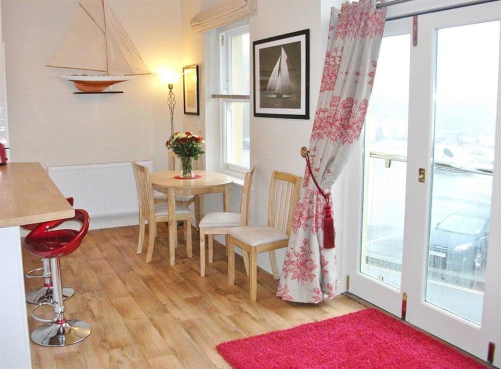 Dining area with a breakfast bar as well as an extending dining table at Watch House in Fowey, Cornwall