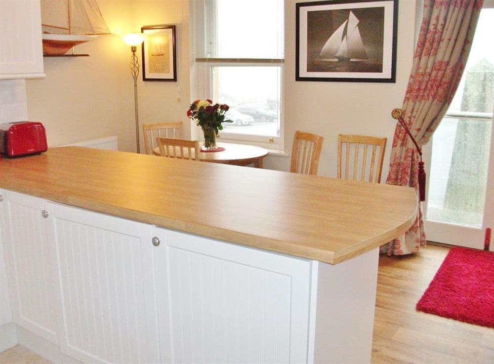 Kitchen with breakfast bar and dining area at Watch House in Fowey, Cornwall