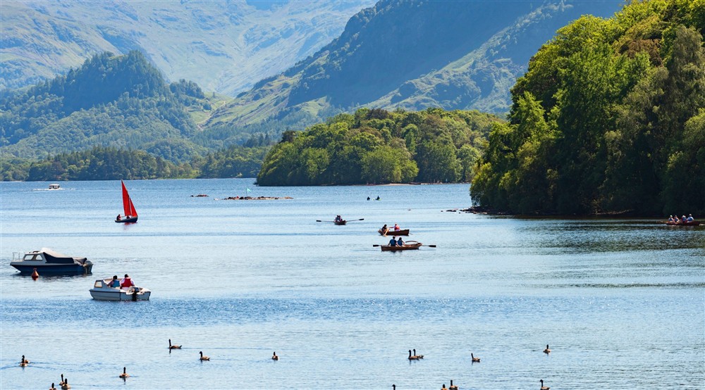 View of boats on Derwent Water on a sunny day at Watendlath Bothy in Keswick, Cumbria