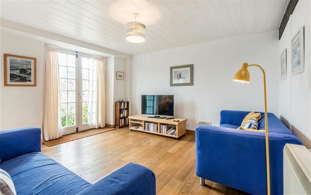 Living room with patio doors at Water Cottage in Lyme Regis