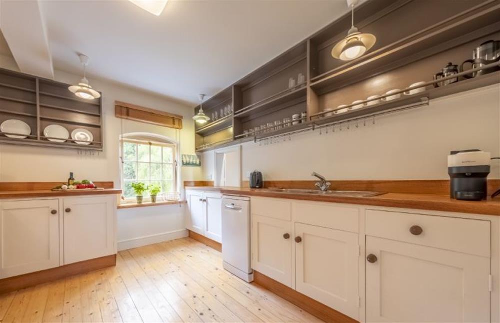 A country-style fitted kitchen view river views at Water Mill House, Burnham Overy Staithe near Kings Lynn