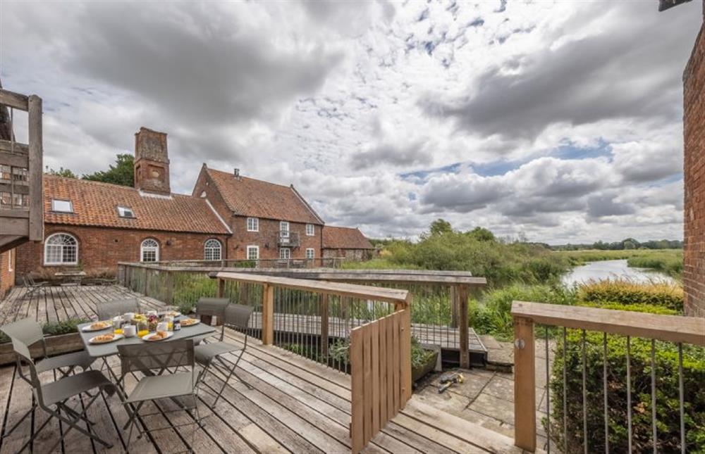 Decked area showing the other residences of the Mill at Water Mill House, Burnham Overy Staithe near Kings Lynn
