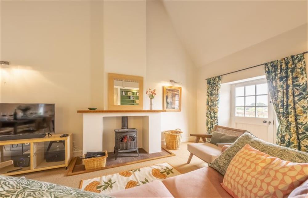 The sitting room has dual aspect river views at Water Mill House, Burnham Overy Staithe near Kings Lynn