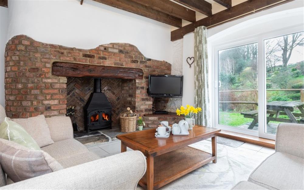 Cosy up by the log burner on the cooler days. at Waterfall Cottage in Stoke Fleming