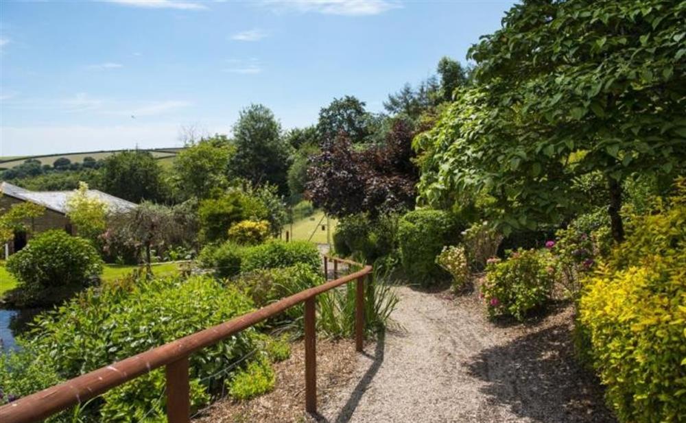 There are scenic paths woven through the communal gardens. at Waterfall Cottage in Stoke Fleming