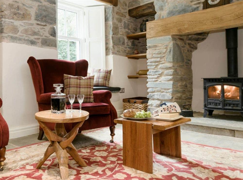 Cosy living room with wood burner at Waterfall Wood Cottage in Glenridding, near Keswick, Cumbria