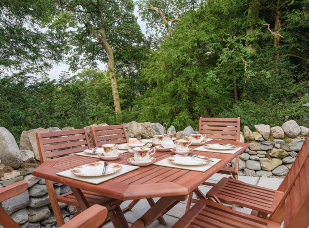 Outdoor dining area in the garden at Waterfall Wood Cottage in Glenridding, near Keswick, Cumbria
