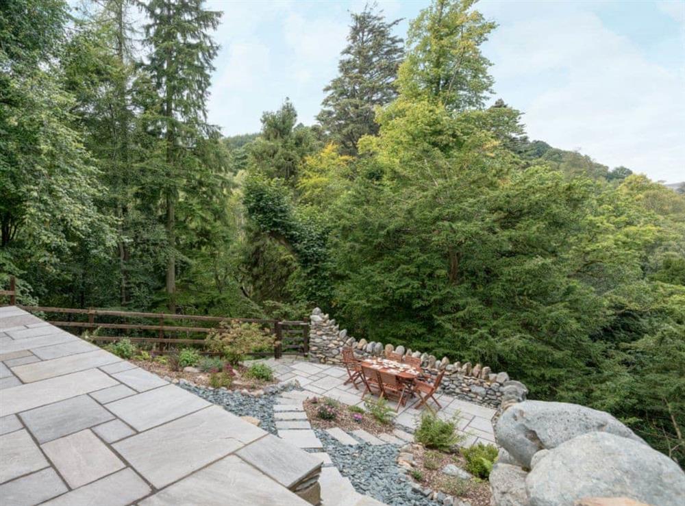Sloping garden with views of the surrounding countryside at Waterfall Wood Cottage in Glenridding, near Keswick, Cumbria