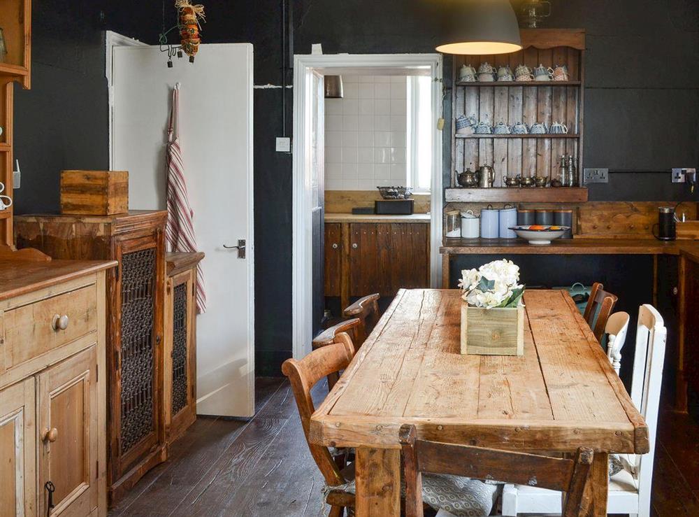 Kitchen with dining area at Waterfront Beach House in Criccieth, near Porthmadog, Gwynedd