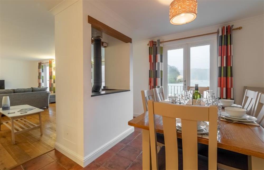 Dinning room with marina views and doors leading to balcony at Waterfront House, Malpas, Truro 