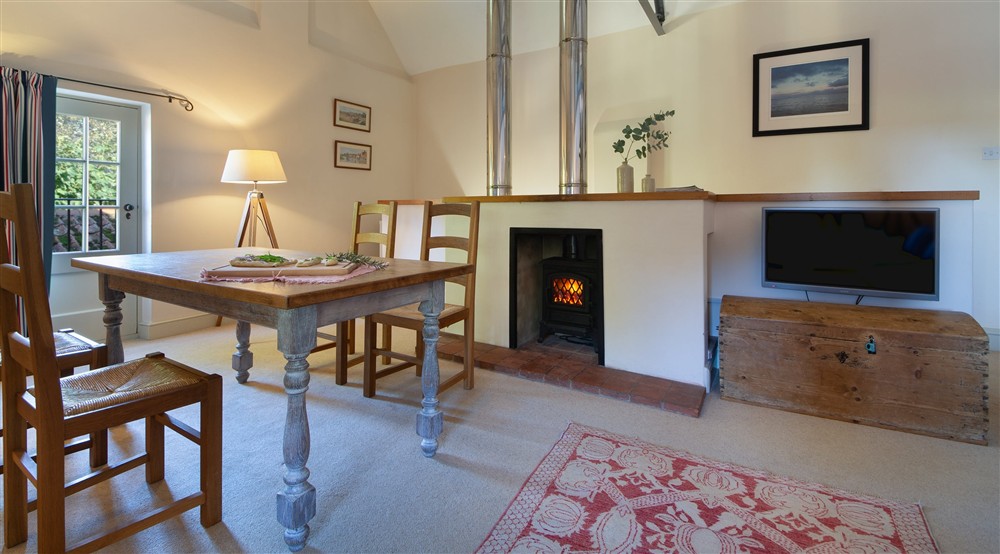 The dining area in the open-plan kitchen, dining and sitting room at Watermill Apartment in Burnham-overy-staithe, Norfolk