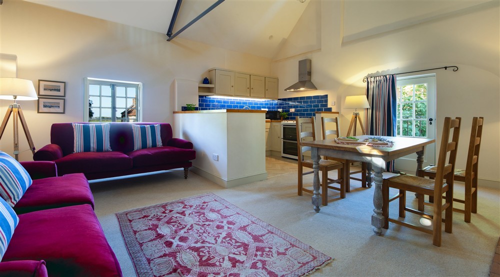 The open-plan kitchen, dining and sitting room at Watermill Apartment in Burnham-overy-staithe, Norfolk